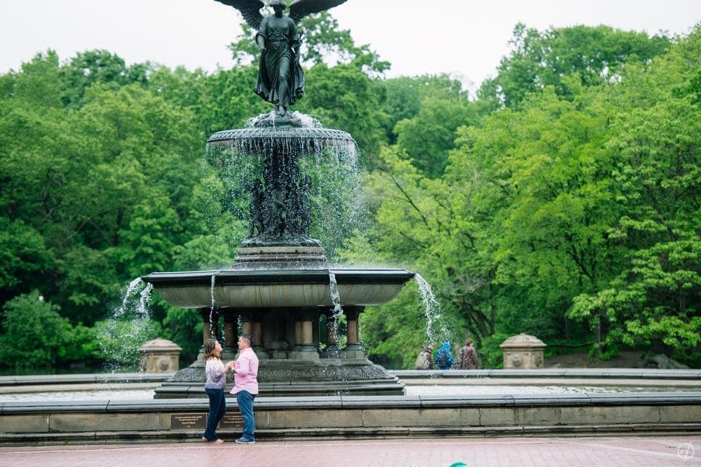 New York City surprise marriage proposal at Bethesda Fountain in Central Park by destination wedding photographer Camille Fontanez