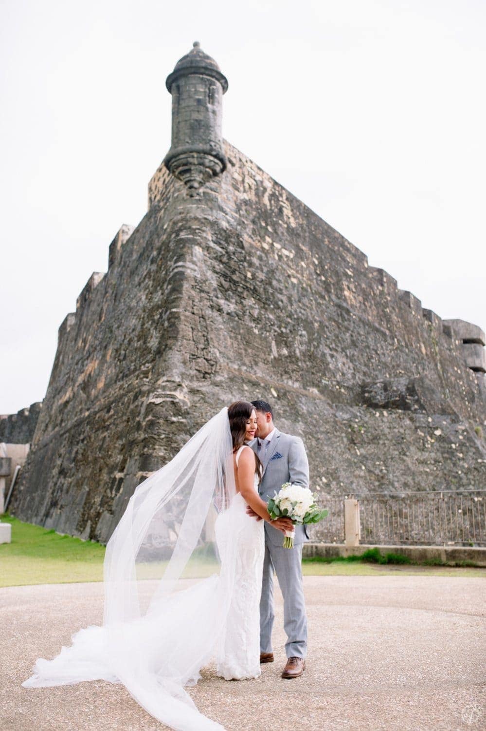 First look session and wedding portraits at Castillo San Cristobal by Puerto Rico wedding photographer