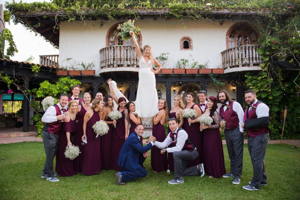 Bridesmaid and groomsmen cheerleader photo with bride on top