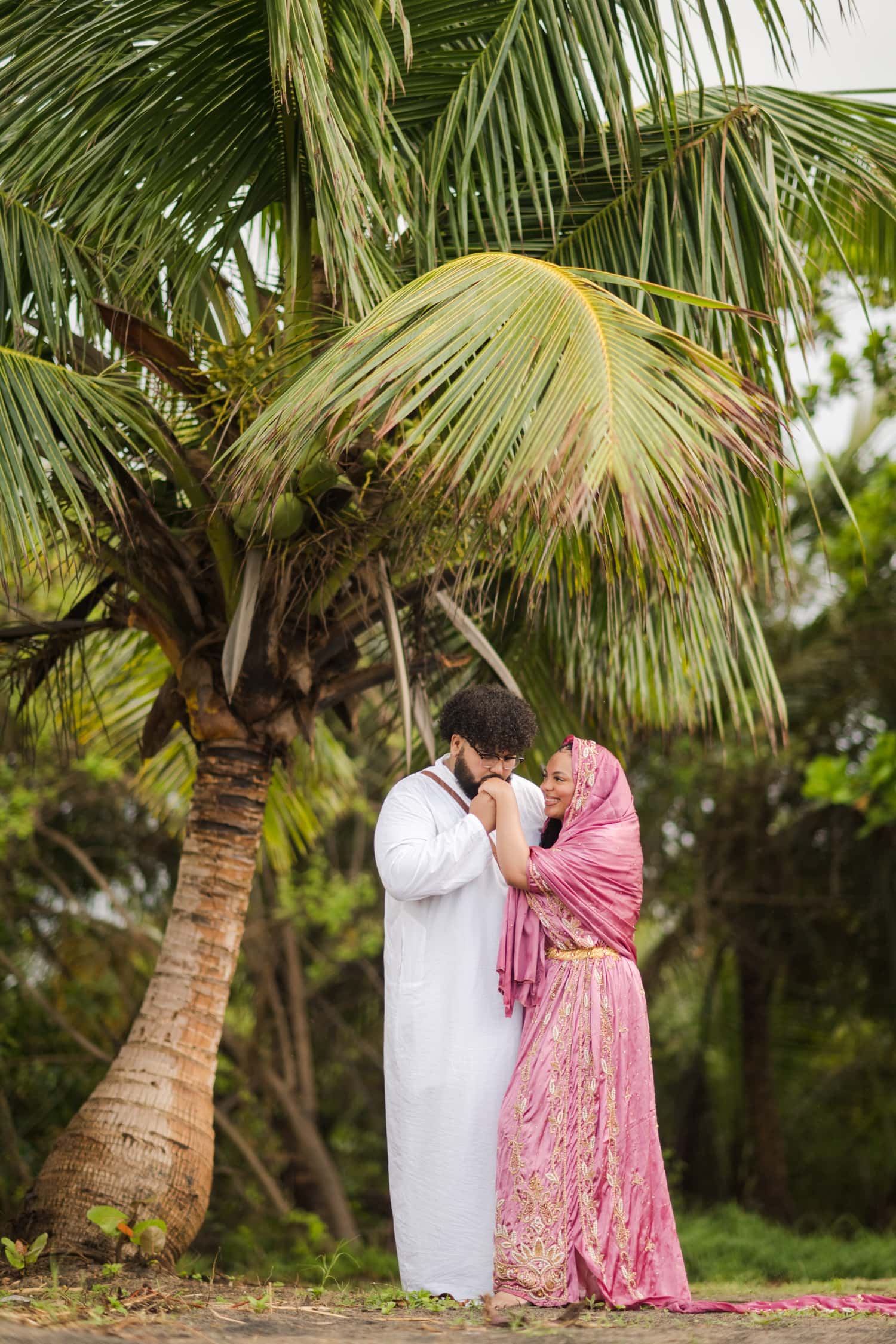 Somali Engagement Photoshoot at Maunabo’s Black Sand Beach. The couple wearing Somali engagement attire on a beach with really unique sand & beautiful views.