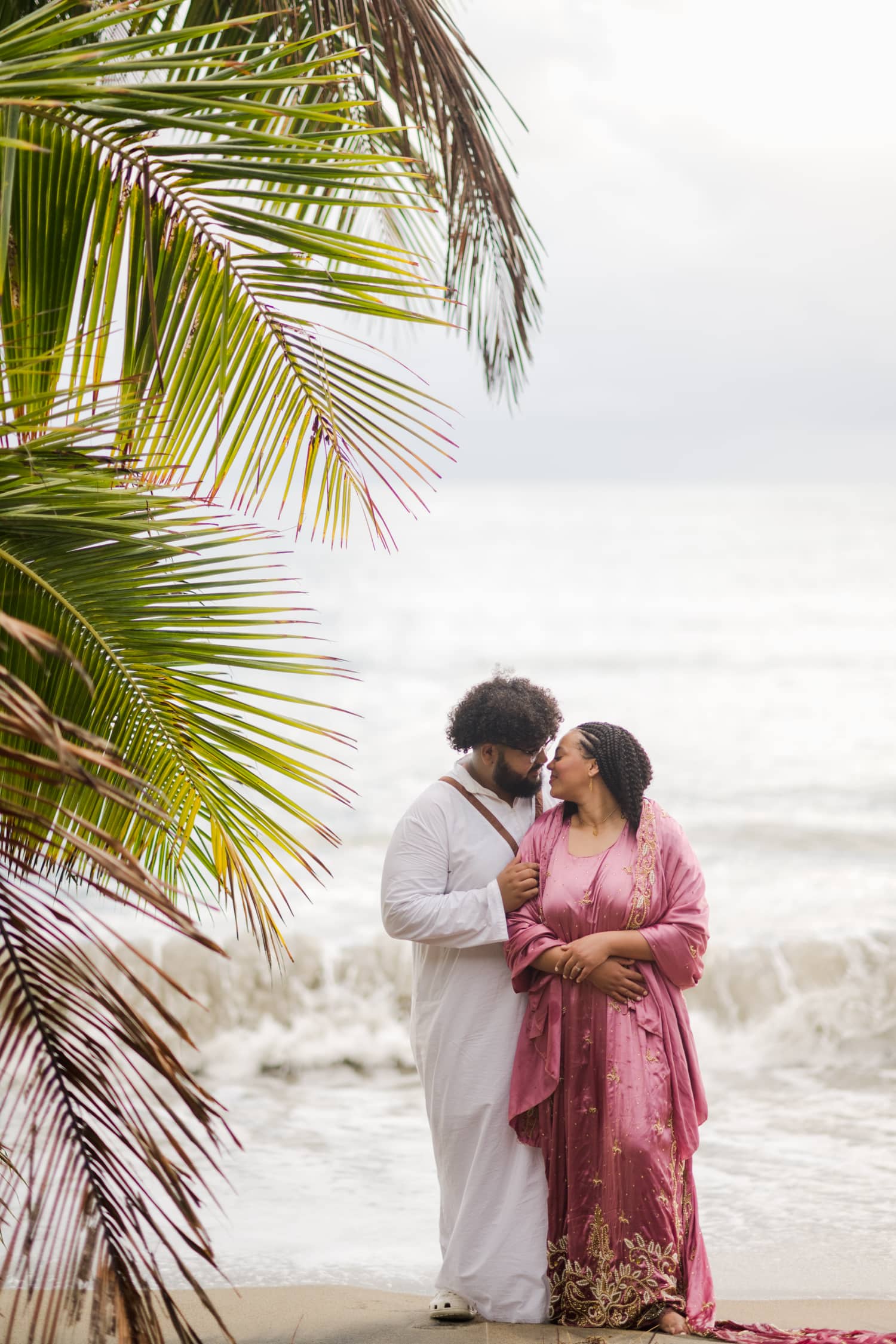 Somali Engagement Photoshoot at Maunabo’s Black Sand Beach. The couple wearing Somali engagement attire on a beach with really unique sand & beautiful views.