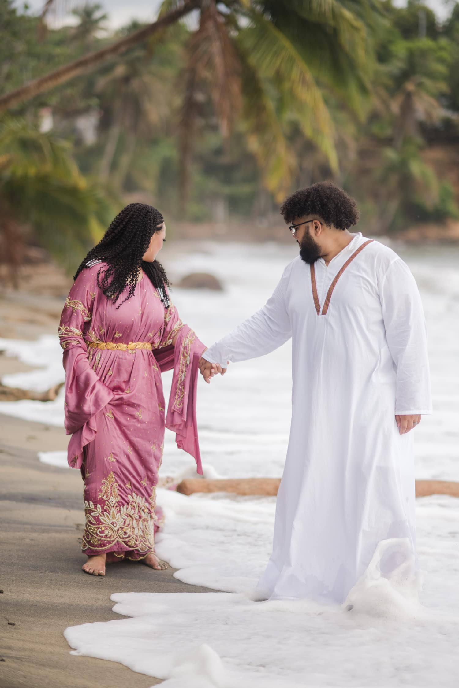 Somali Engagement Photoshoot at Maunabo’s Black Sand Beach. The couple wearing Somali engagement attire on a beach with really unique sand & beautiful views.