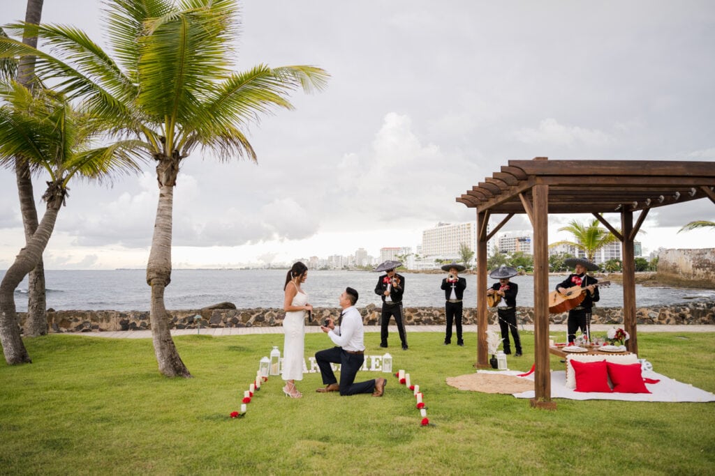 caribe hilton proposal photography with mariachis and a picnic setup