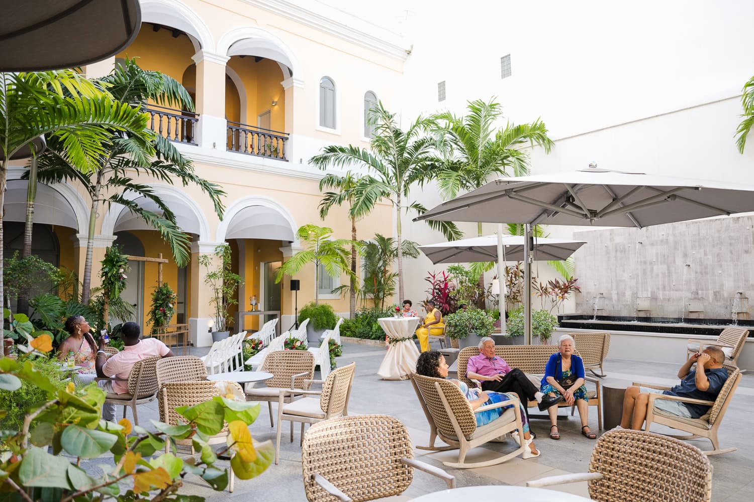 Wedding guests relaxing in the courtyard of a historic venue during an intimate destination wedding in Old San Juan.