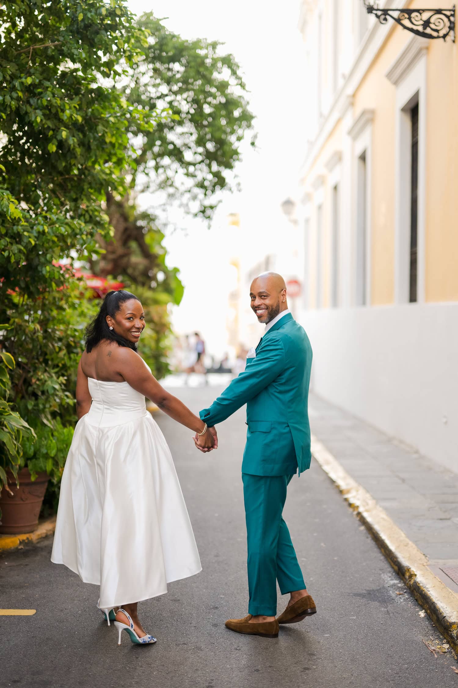 Couple walking through the colorful streets of Old San Juan during their intimate destination wedding photoshoot.