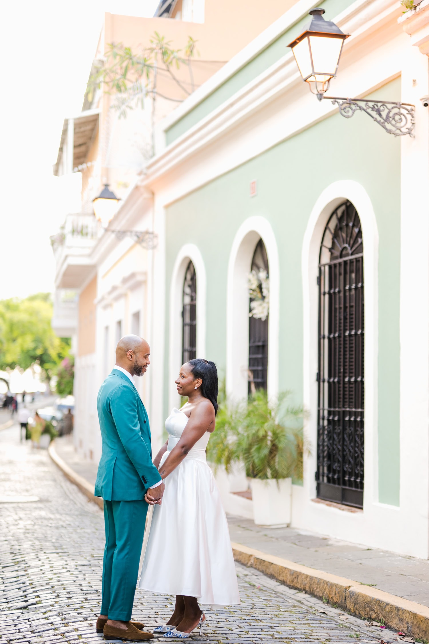 Couple sharing a tender embrace in a charming outdoor setting during their intimate destination wedding in Old San Juan