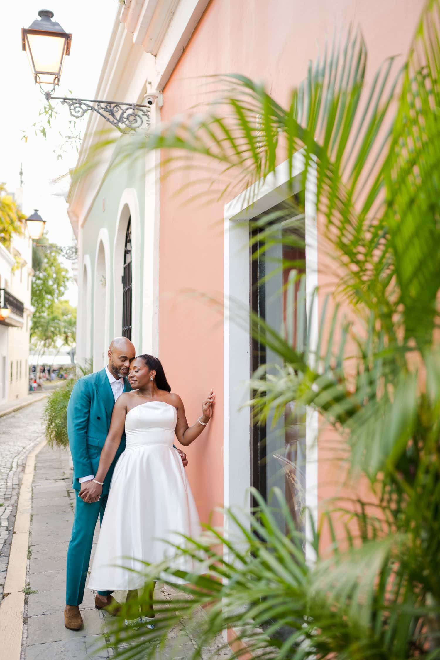 Couple sharing a tender embrace in a charming outdoor setting during their intimate destination wedding in Old San Juan