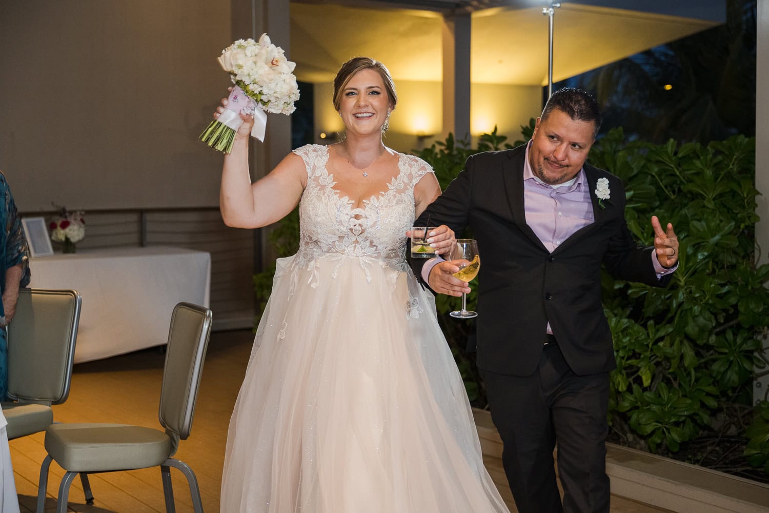 Beachfront wedding ceremony setup with a floral arch and palm trees at Courtyard Marriott Isla Verde, Puerto Rico.