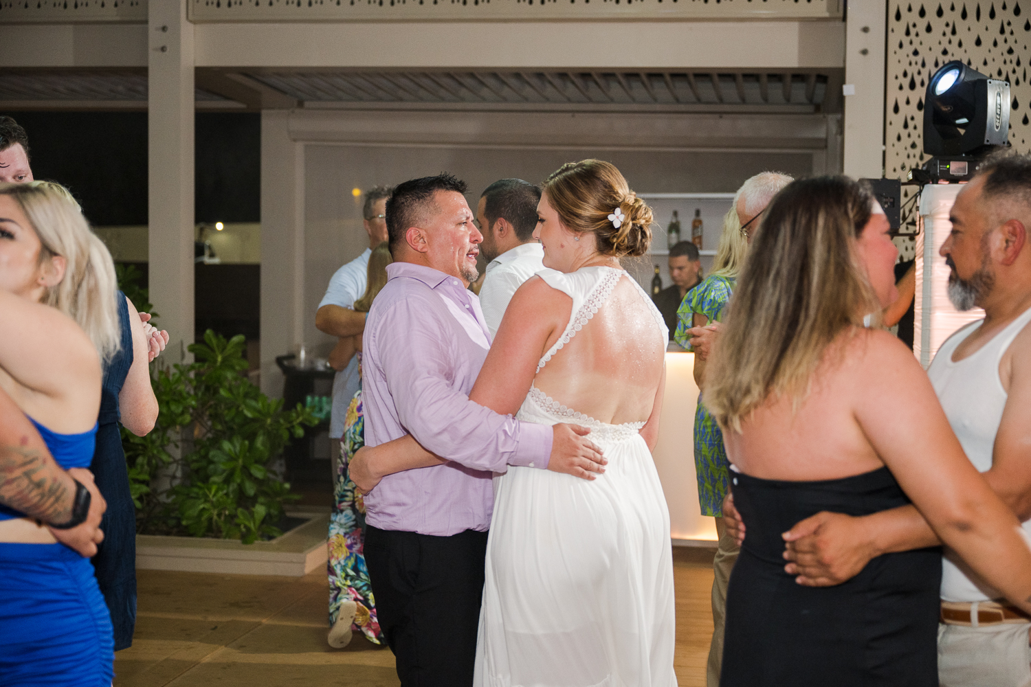 Beachfront wedding ceremony setup with a floral arch and palm trees at Courtyard Marriott Isla Verde, Puerto Rico.