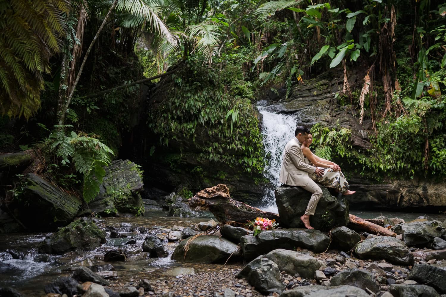 Couple exchanging vows at Juan Diego Falls, El Yunque National Forest