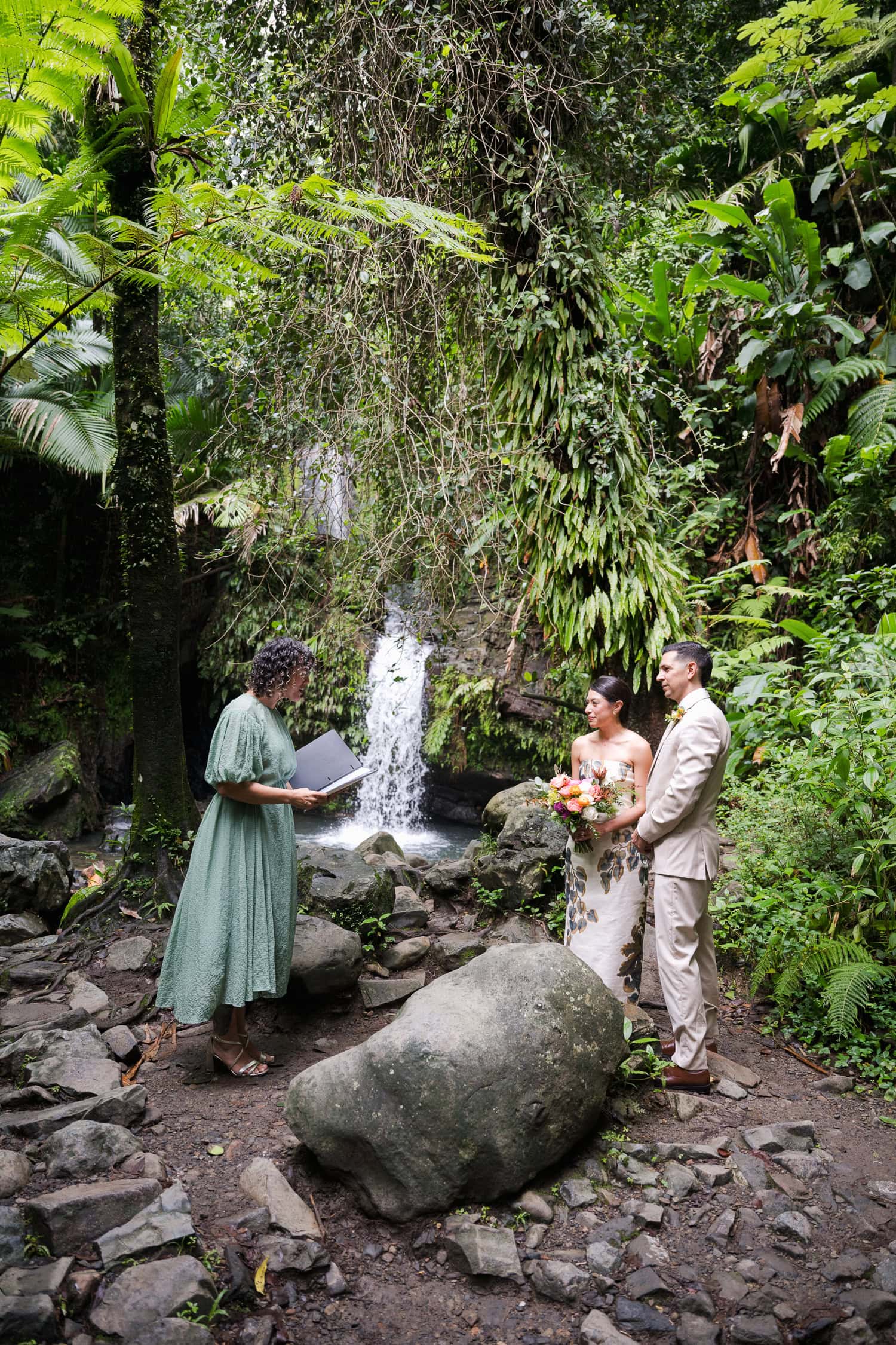 Couple exchanging vows at Juan Diego Falls, El Yunque National Forest