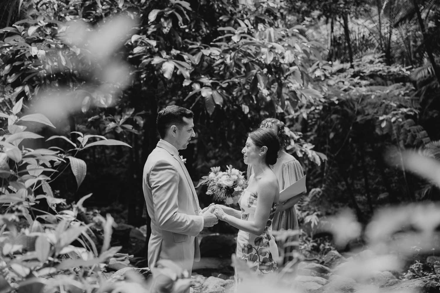 Couple exchanging vows at Juan Diego Falls, El Yunque National Forest