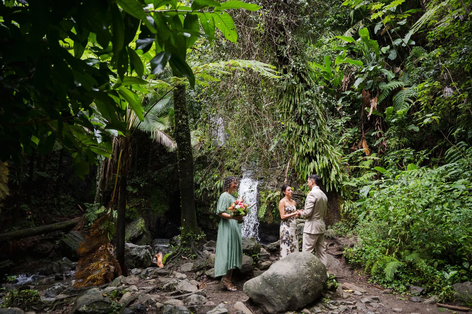 Couple exchanging vows at Juan Diego Falls, El Yunque National Forest