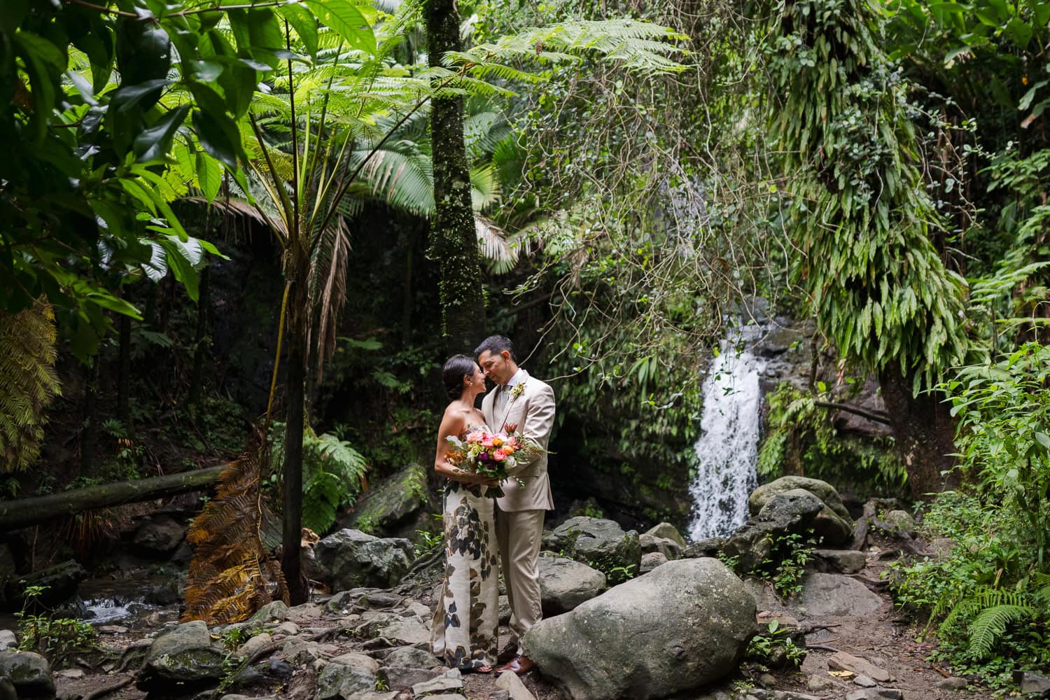 Couple exchanging vows at Juan Diego Falls, El Yunque National Forest