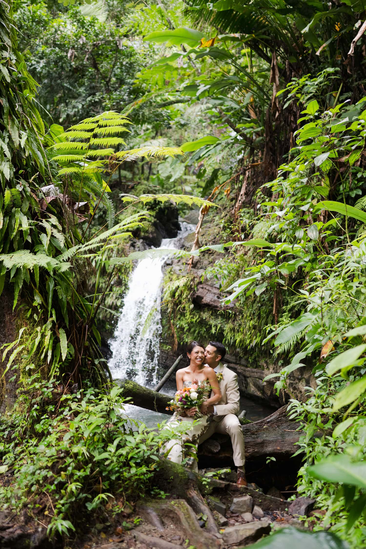 Couple exchanging vows at Juan Diego Falls, El Yunque National Forest