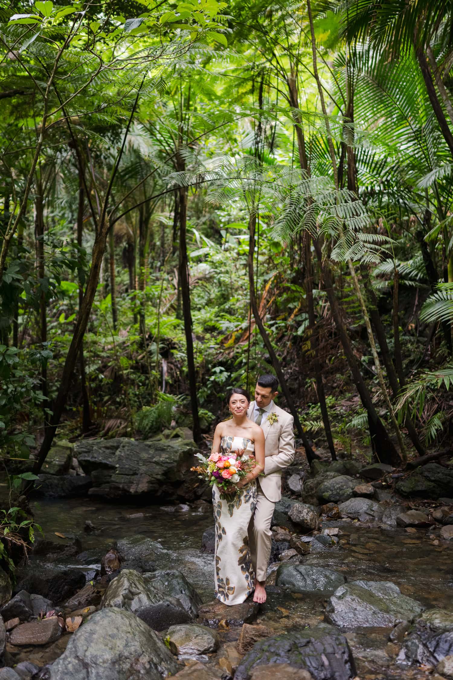 Couple exchanging vows at Juan Diego Falls, El Yunque National Forest