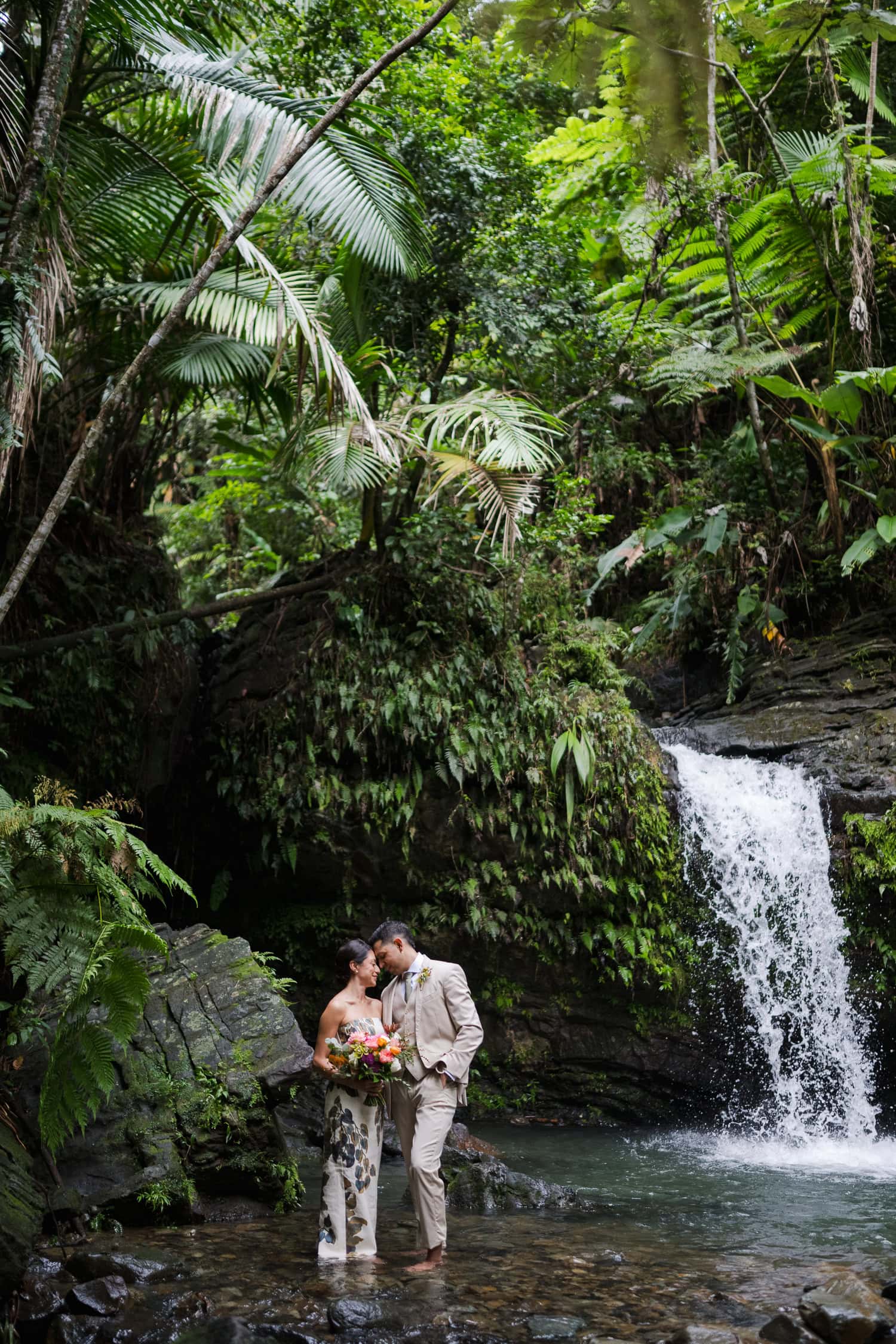 Couple exchanging vows at Juan Diego Falls, El Yunque National Forest