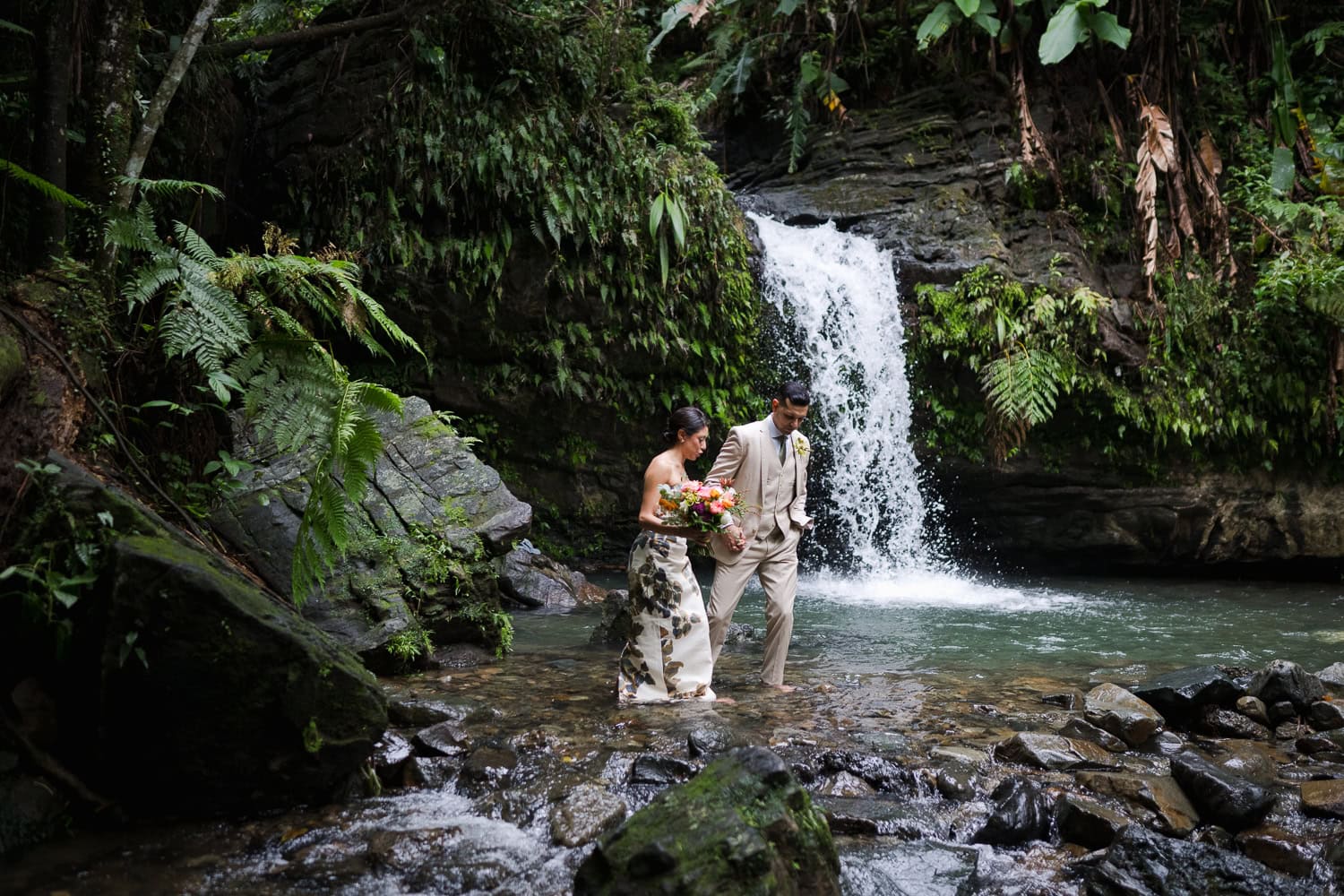 Couple exchanging vows at Juan Diego Falls, El Yunque National Forest