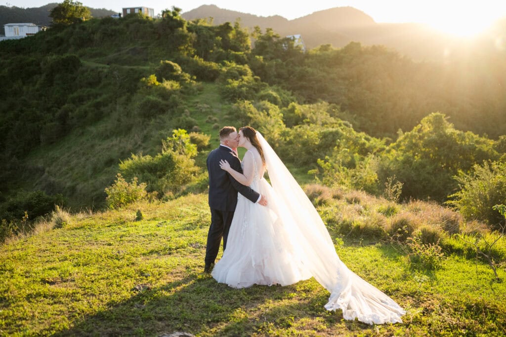 Somos Instantes Airbnb wedding in the mountains of Puerto Rico Somos Instantes Airbnb Wedding Cayey Couple kissing at golden hour in the hills of Cayey