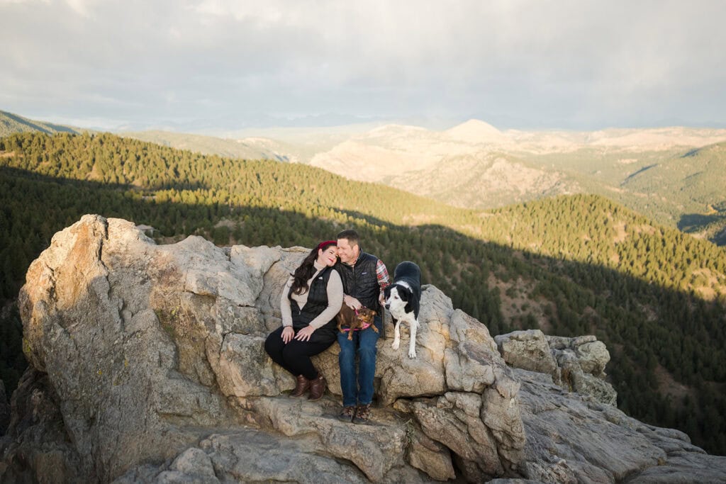 couple standing on rocky cliffs at Lost Gulch Overlook with mountain views
