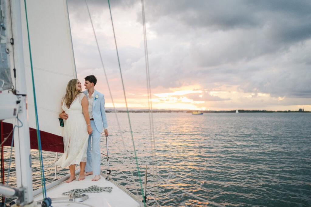 Couple exchanging vows during sunset sail in San Juan