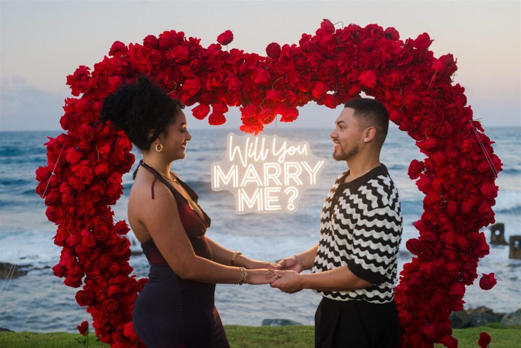 Neon will you marry me sign and red roses in Puerto Rico beachfront proposal