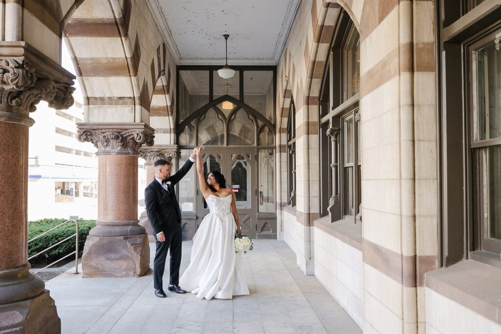 Bride and groom portrait under arched colonnade at The Old Post Office Evansville Indiana