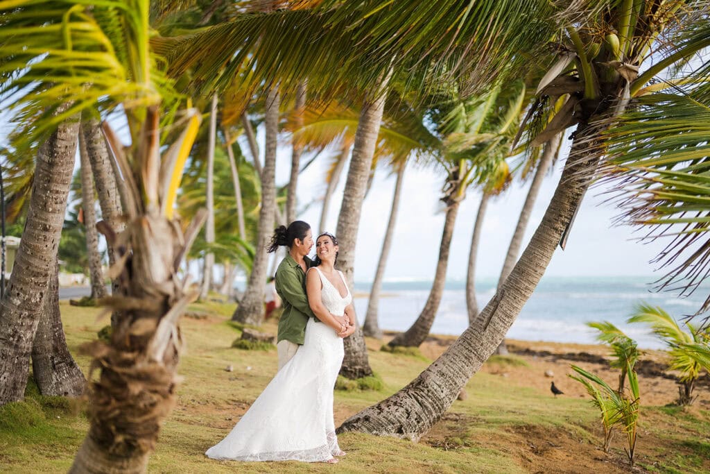 Bride and groom embracing at the shoreline during small beach wedding at Playa Azul Luquillo Puerto Rico