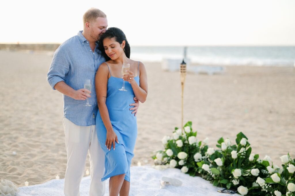 A sunset beach picnic proposal at La Concha Resort in Condado. Candles, torches, and an oceanfront surprise she never saw coming, photographed by Camille Fontz.